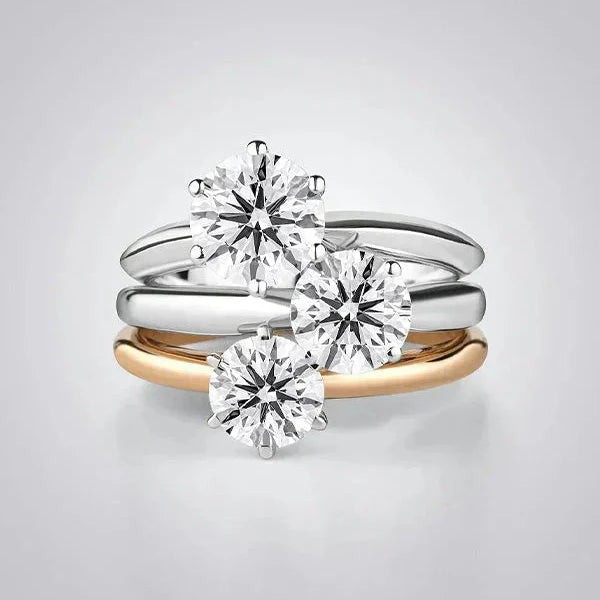 Stacked 925 silver and gold-plated rings with large round cubic zirconia stones