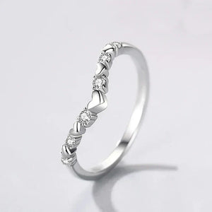 925 silver heart-shaped ring with clear gemstones on white background