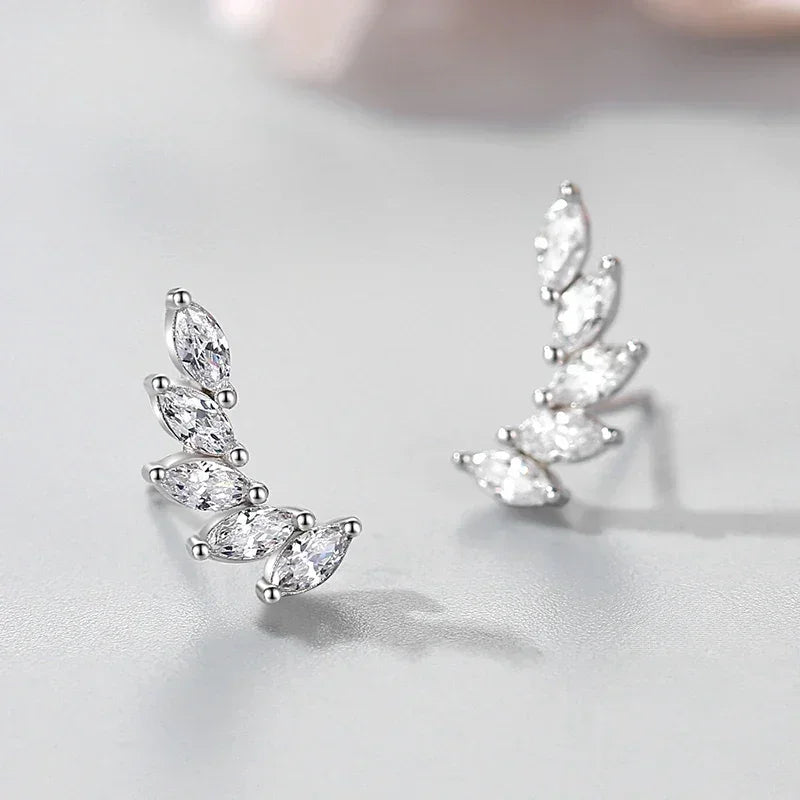 Sterling silver ear climber earrings with marquise-cut clear stones on light gray background