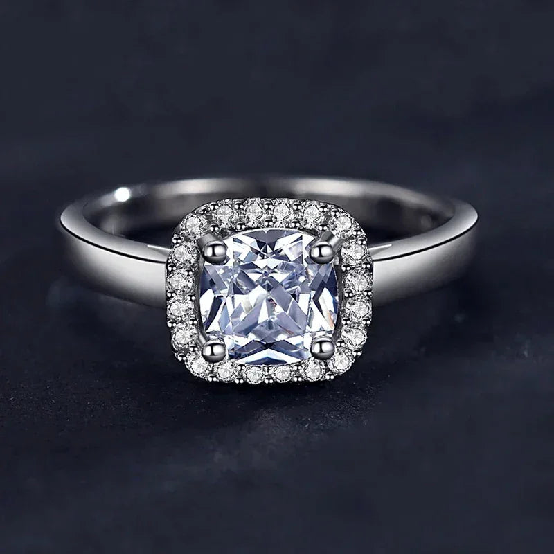 925 silver ring with cushion-cut center stone and pavé halo setting on dark background
