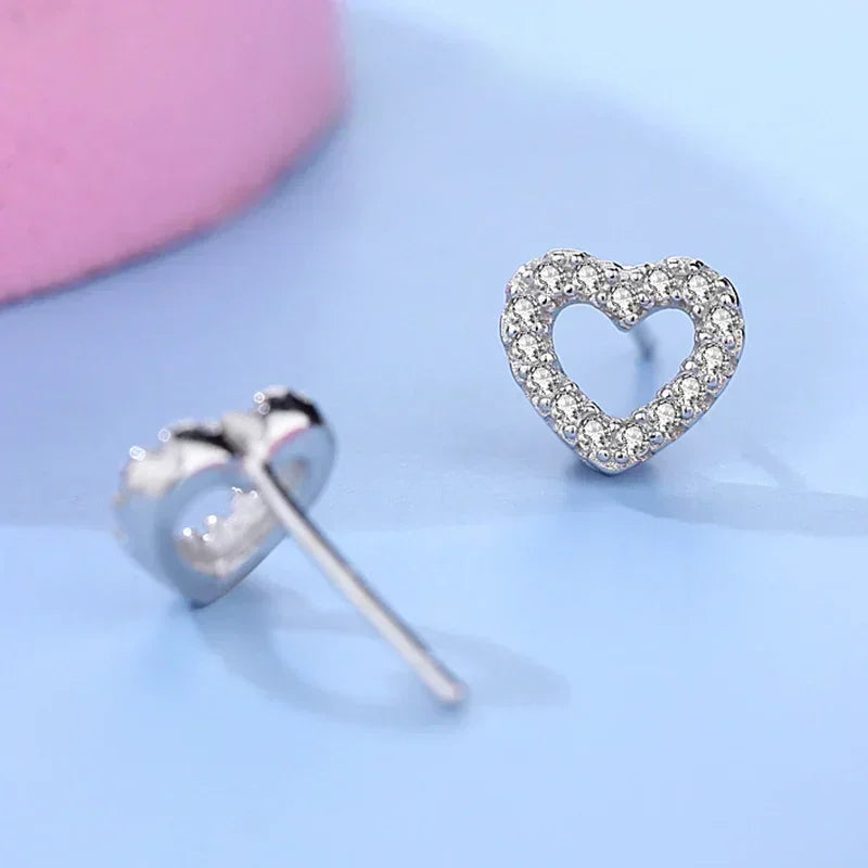 925 silver heart stud earrings with cubic zirconia, elegant women's jewelry on blue background