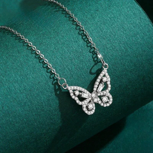 Silver butterfly necklace on a green fabric background-Butterfly Bliss Necklace - TM & CO. JEWELS 