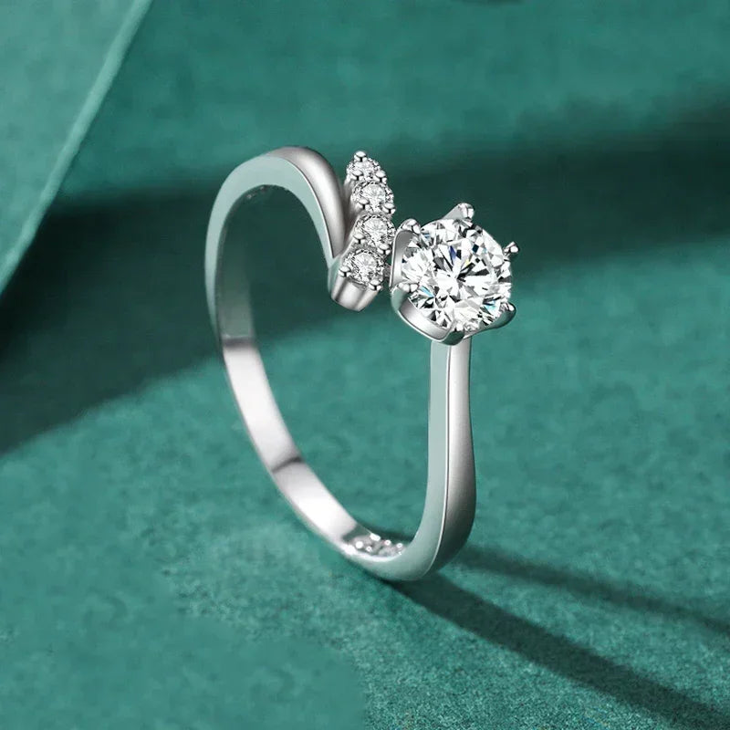 Elegant 925 silver solitaire ring with side accent stones on teal background