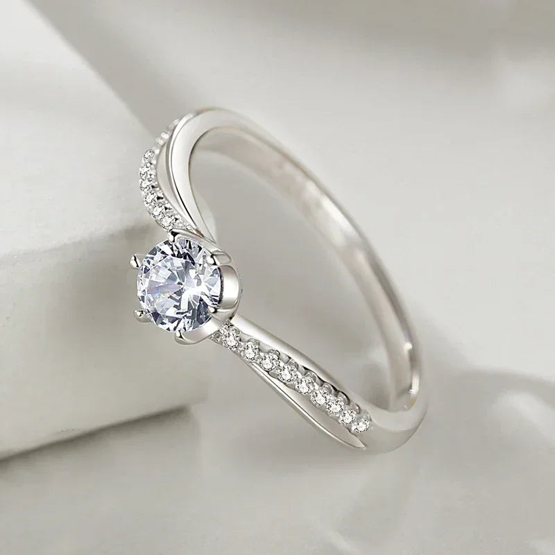 Elegant sterling silver ring with round center stone and pavé-set accent stones