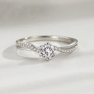 Sterling silver ring with round solitaire center and pave accent stones on twisted band