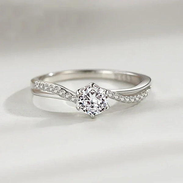 Sterling silver ring with round solitaire center and pave accent stones on twisted band