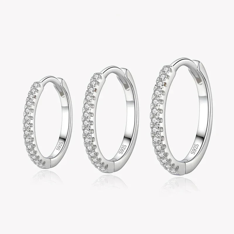 Three sterling silver hoop earrings with pavé cubic zirconia, displayed on a white background.