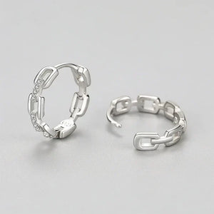 Pair of silver hoop earrings on a light gray background