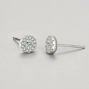 Pair of diamond stud earrings on a light gray background