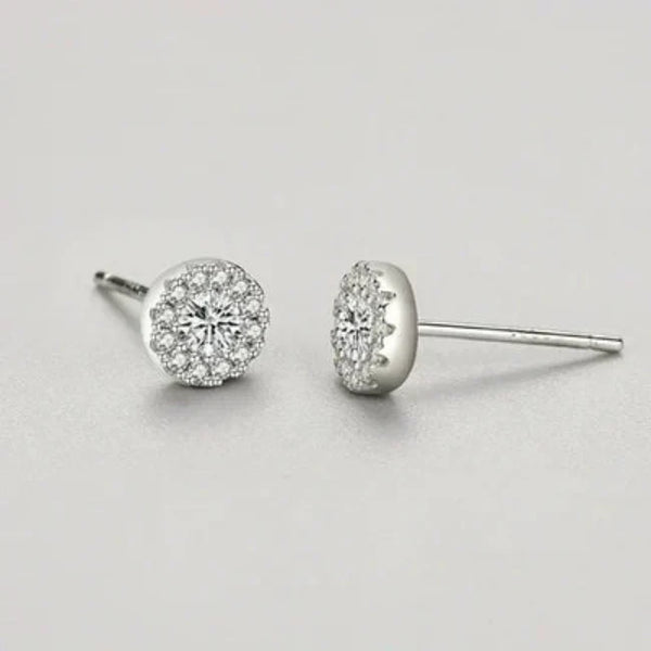 Pair of diamond stud earrings on a light gray background