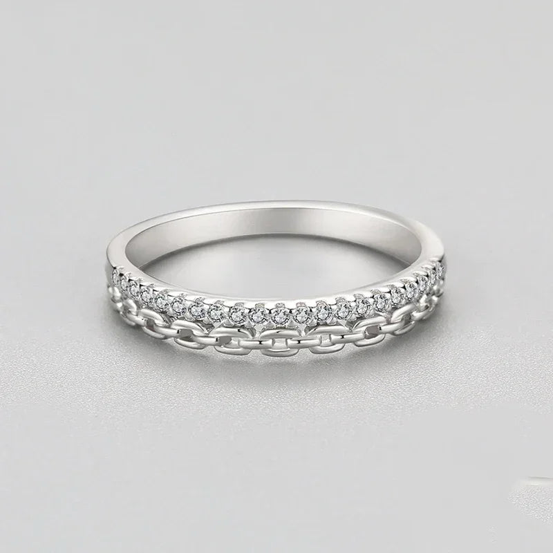 925 silver ring with chain detail and sparkling round stones on a neutral background