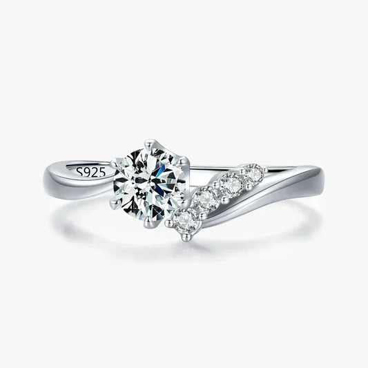 925 silver ring with round-cut center stone and side accent cubic zirconia on a white background