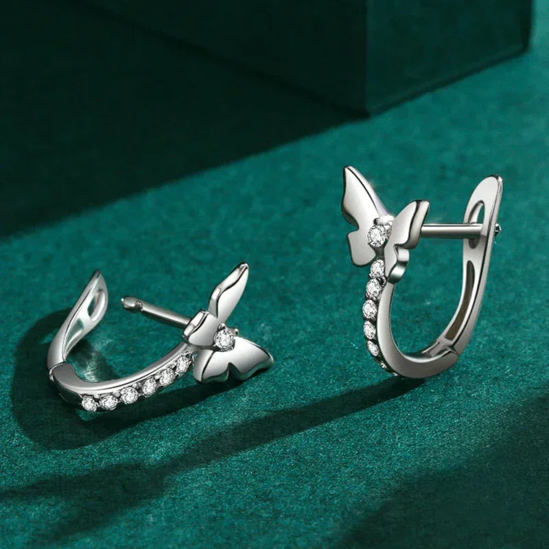 925 silver butterfly hoop earrings with sparkling cubic zirconia on green background
