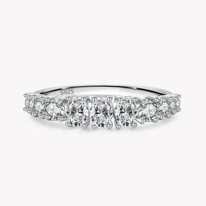 925 sterling silver ring with round white gemstones in a row on a plain background
