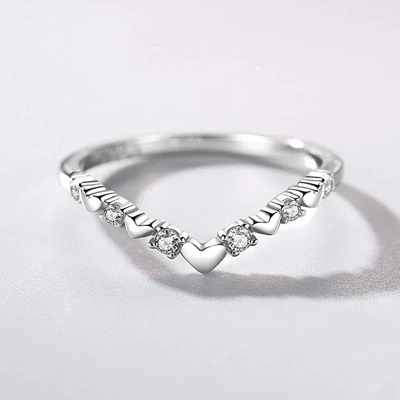 925 silver heart-shaped ring with clear gemstones on white background