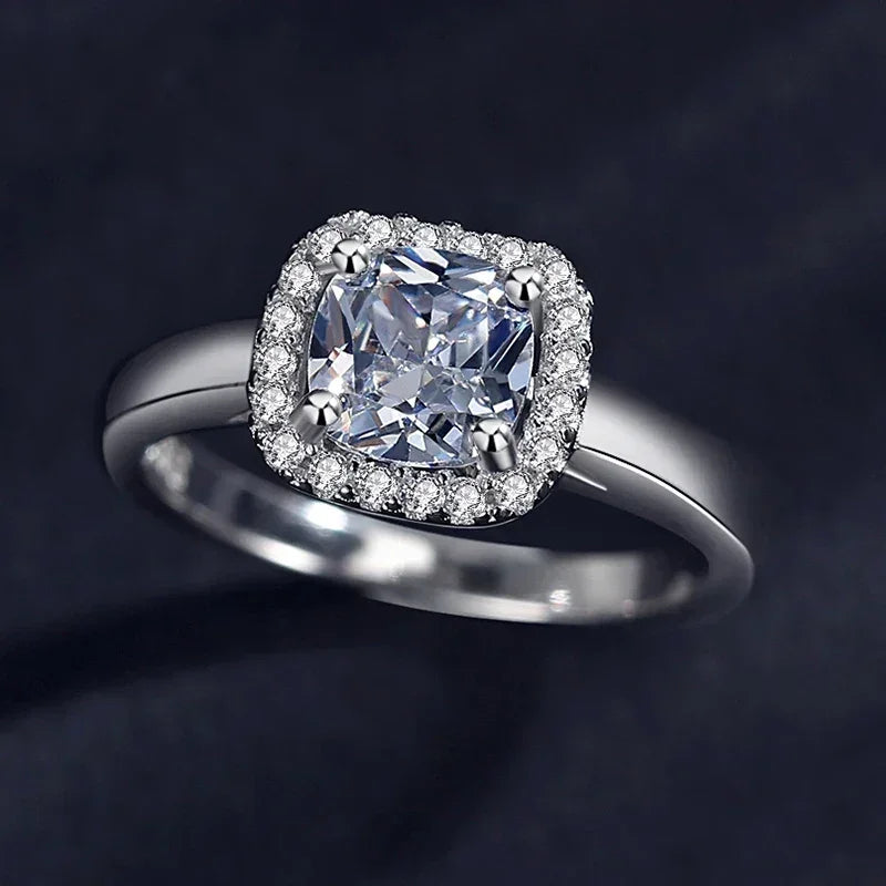 925 silver ring with cushion-cut center stone and pavé halo on dark background