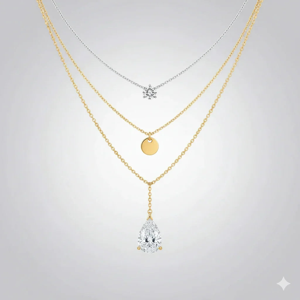 Three gold necklaces with diamond pendants on a light gray background