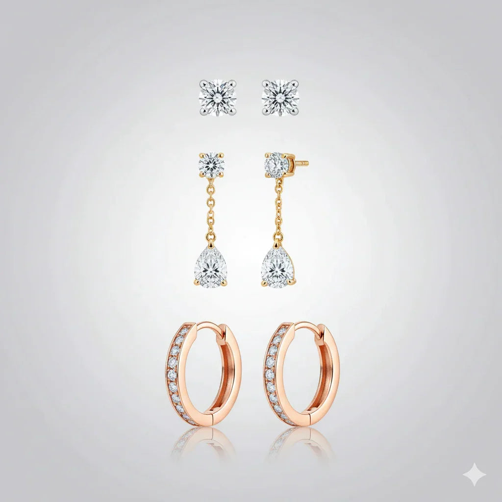 Set of diamond earrings on a light gray background