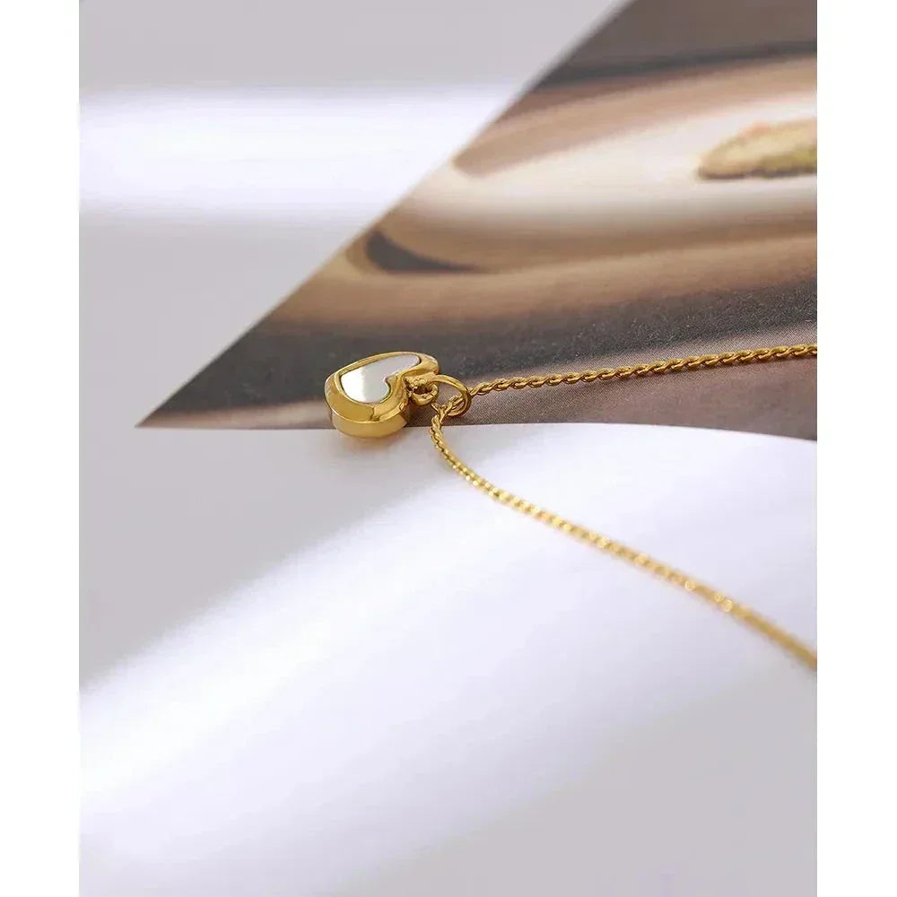 Gold-plated heart pendant necklace on gold chain, minimalist jewelry design