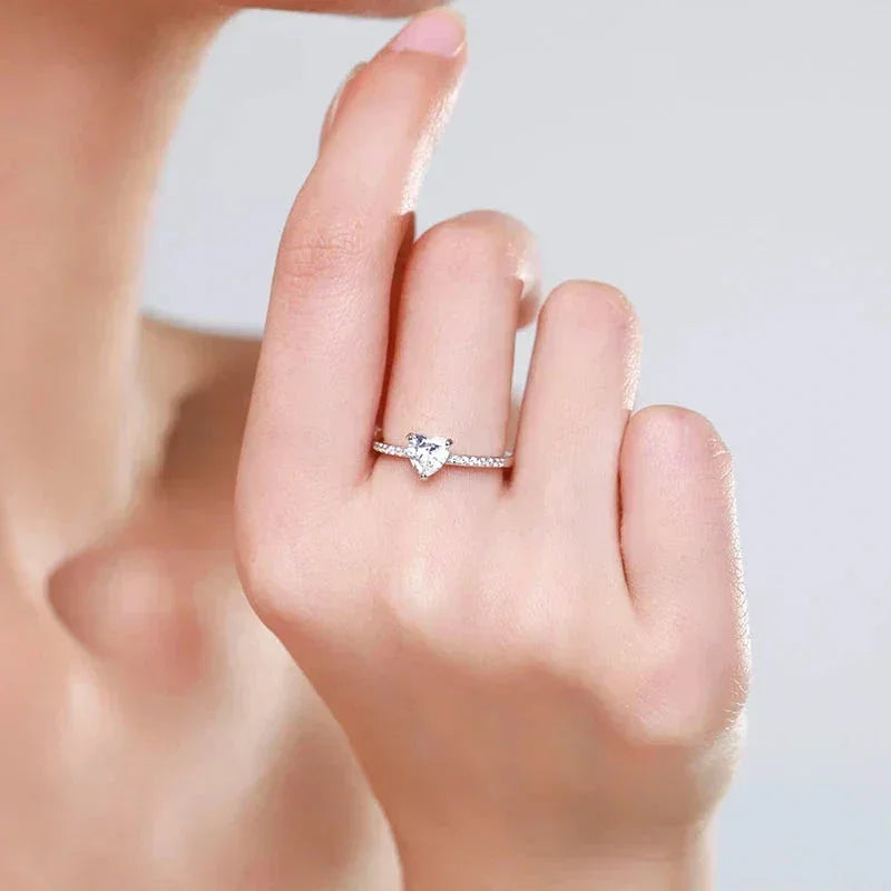 Elegant woman's hand wearing a heart-shaped 925 silver and cubic zirconia ring