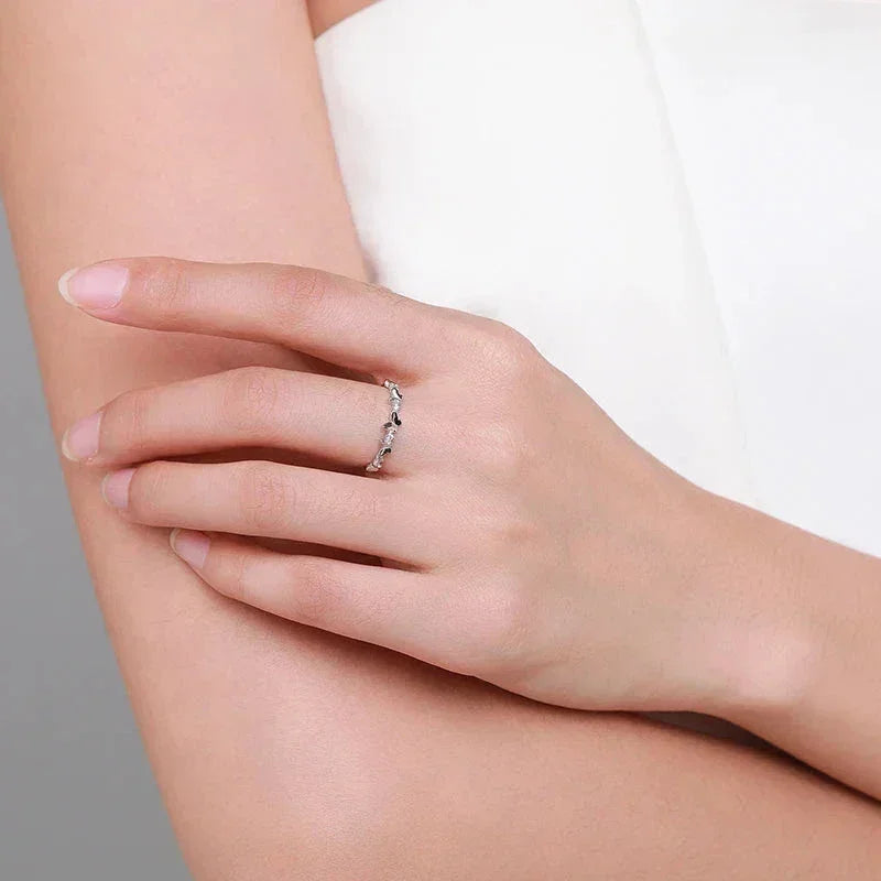 Hand wearing delicate 925 silver ring with leaf design, minimalist women's jewelry