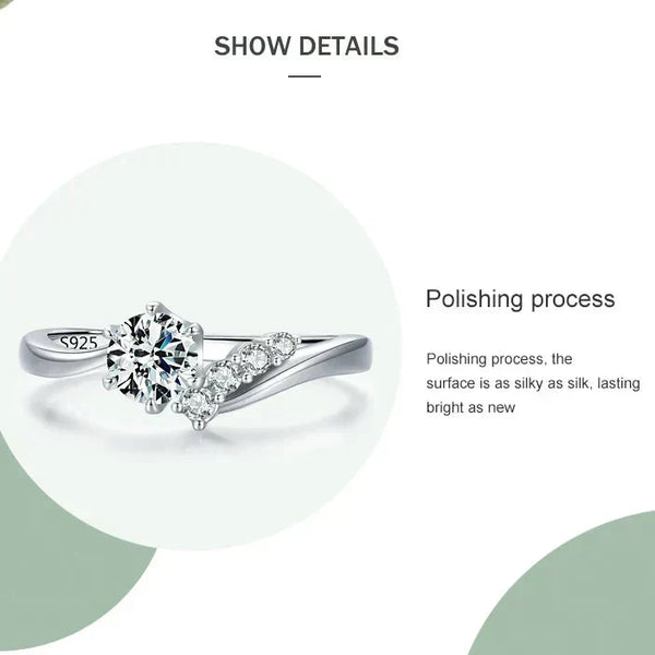 925 silver ring with round-cut center stone and side accent cubic zirconia on a white background