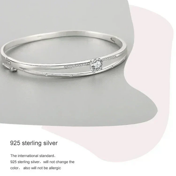 925 sterling silver bangle bracelet with central round cubic zirconia and delicate side stones