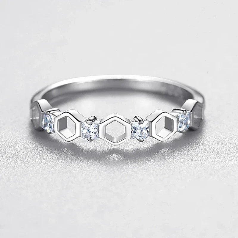925 silver ring with hexagon shapes and small clear gemstones on a light background