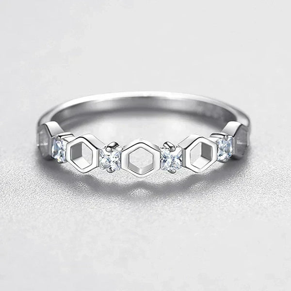 925 silver ring with hexagon shapes and small clear gemstones on a light background