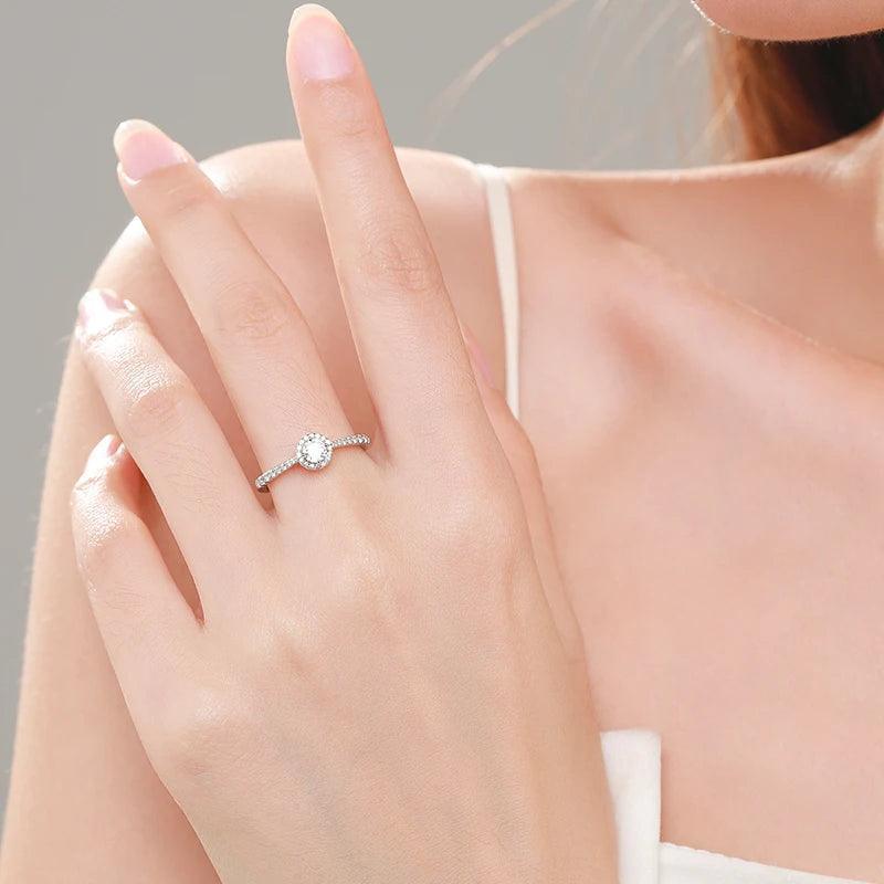 Woman wearing an elegant silver halo solitaire ring on her left hand