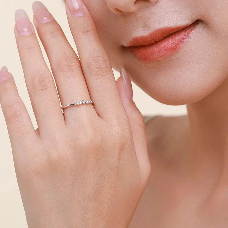 Close-up of woman's hand wearing a delicate 925 silver ring with small stones