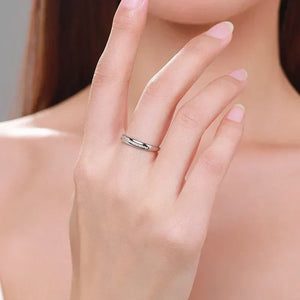 Woman wearing a minimalist 925 silver ring on her finger, close-up jewelry shot