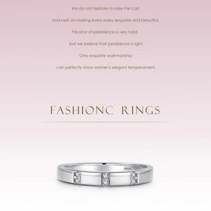 Silver ring with diamonds on a light pink background with text about craftsmanship.