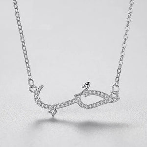 Silver necklace with a unique pendant on a light gray background