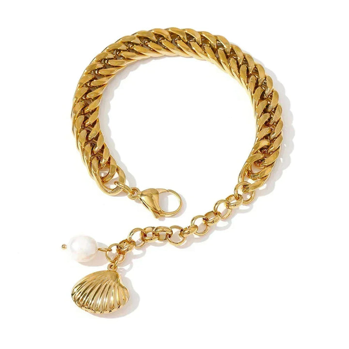 Gold chain bracelet with shell and pearl charm on a white background