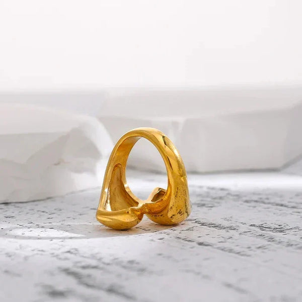 18K gold-plated sculptural open ring for women on white stone background