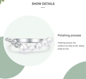 Silver ring with pearls on a white background