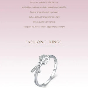 Sterling silver ring with a bow design and sparkling cubic zirconia accents- TM & CO. JEWELS 