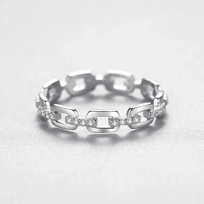 925 silver chain link ring with sparkling clear stones on a light background