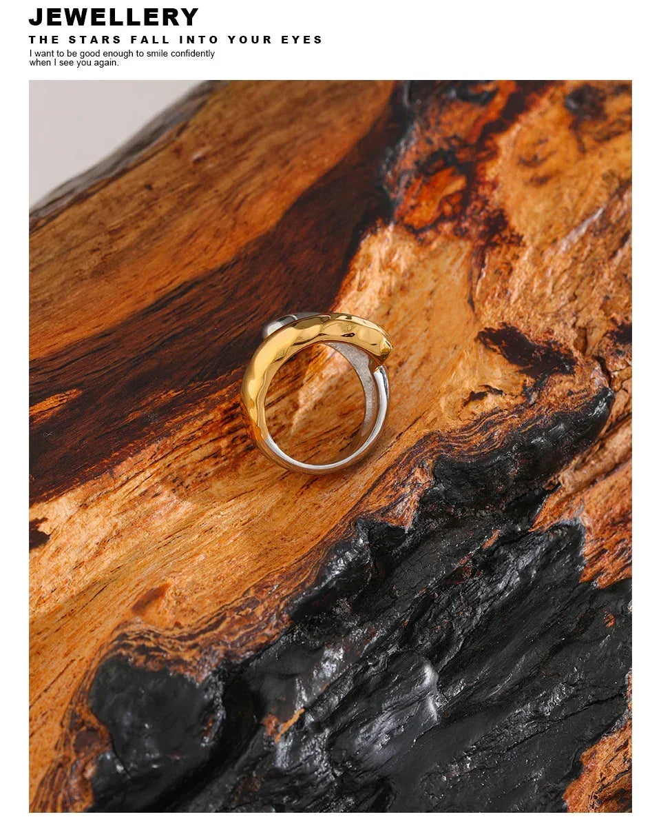 18K gold-plated and 925 silver ring with organic design on textured wood background