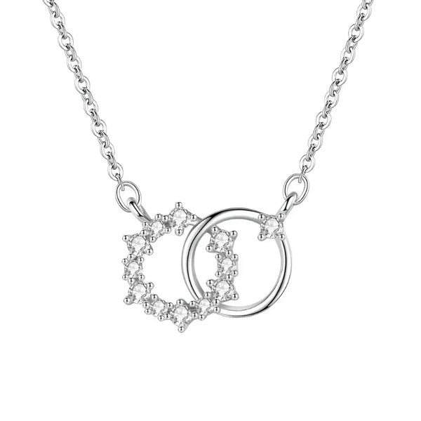 Silver necklace with interlocking heart and circle pendants on a white background