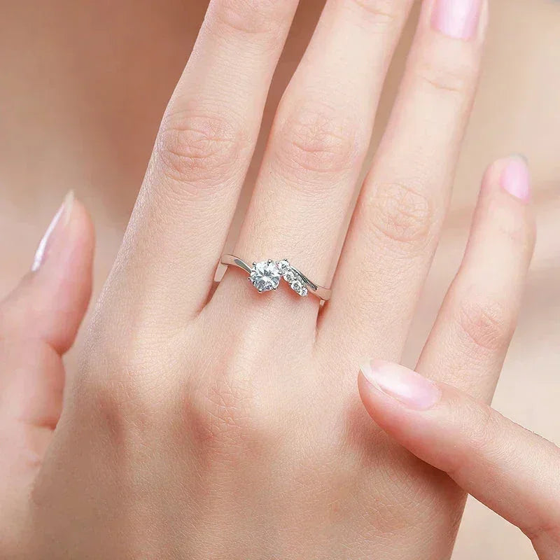 Hand wearing a 925 silver ring with sparkling round gemstones, elegant jewelry for women