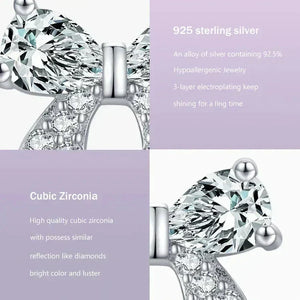 Earring with cubic zirconia stones on a purple background with product details text.