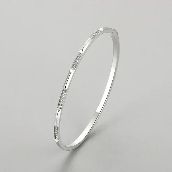 925 silver bangle bracelet with cubic zirconia accents on a white background