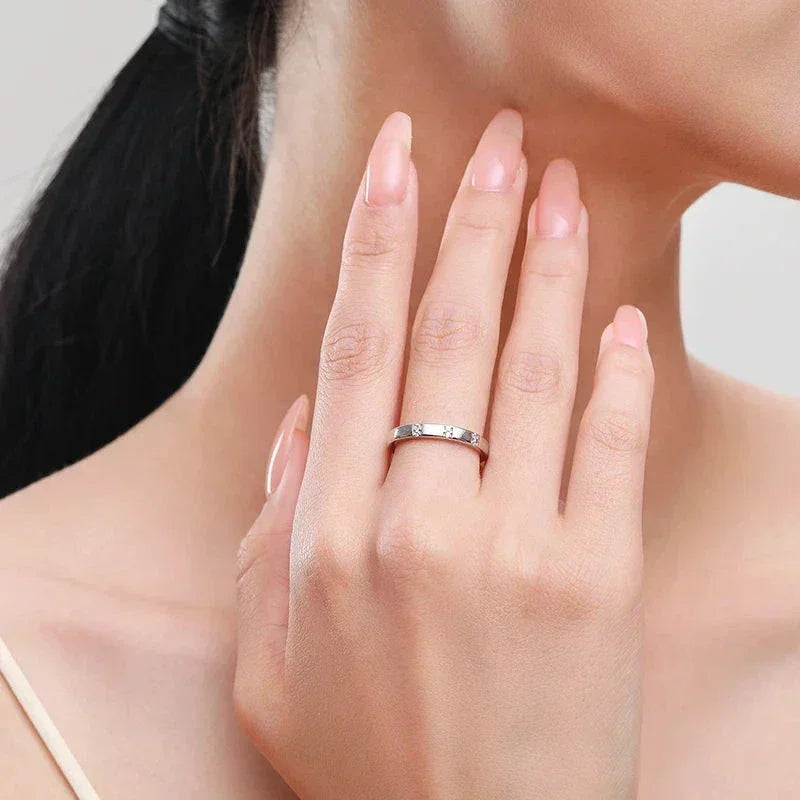 Woman wearing a minimalist 925 silver ring with subtle gemstone accents on her finger