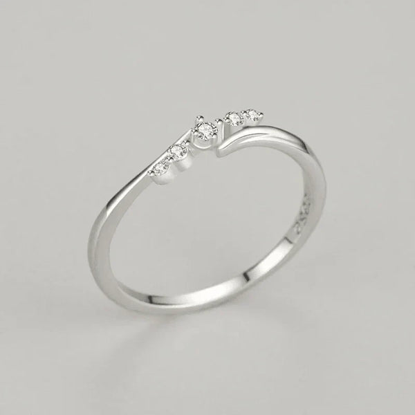 925 silver ring with small round white stones in minimalist setting on gray background