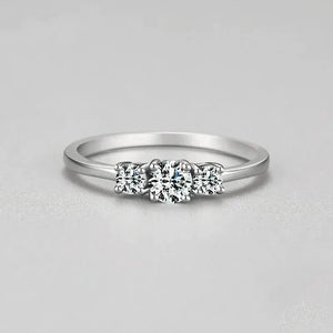 Sterling silver ring with three round clear stones on a plain band, minimalist jewelry