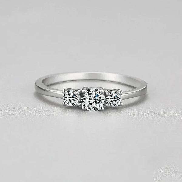 Sterling silver ring with three round clear stones on a plain band, minimalist jewelry