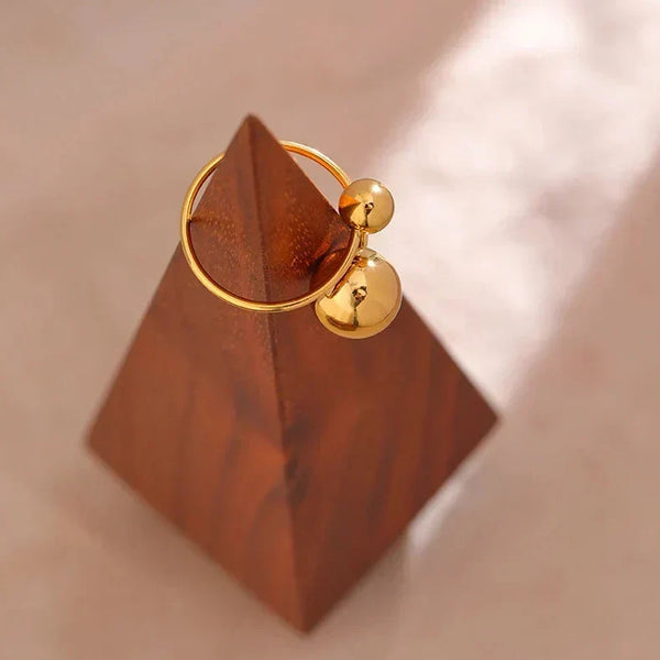 18K gold-plated ring with two polished sphere accents on white background - TM & CO. JEWELS 