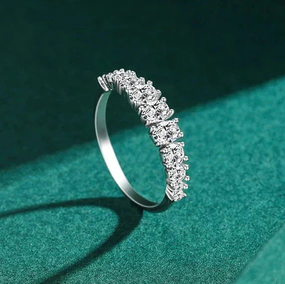 Silver ring with diamonds on a green background
